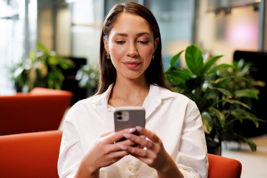 Business Woman Using Smartphone in Office

