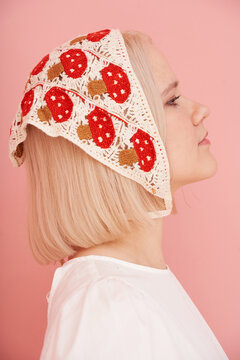 Woman in profile wearing a decorative headscarf
