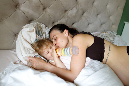 pregnant mother and child spending time at home