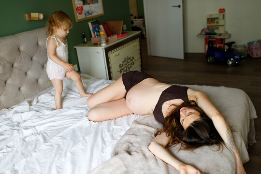 pregnant mother and child spending time at home