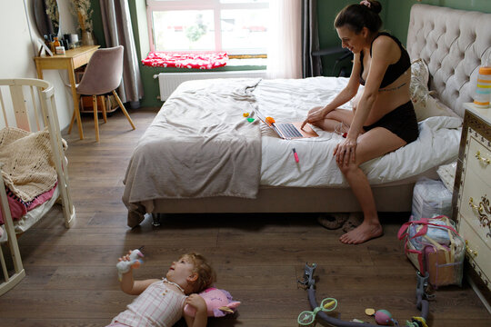 pregnant mother and child spending time at home