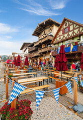 Sidewalk cafes and Bavarian themed shops along the festive and colorful main street of the mountain town of Leavenworth, in the Cascade mountains of Washington State. © Kirk Fisher