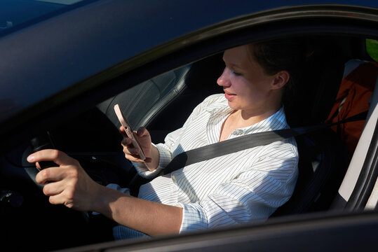 Person using smartphone while seated in car