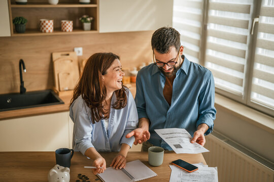 Couple discussing monthly budget and managing household finances