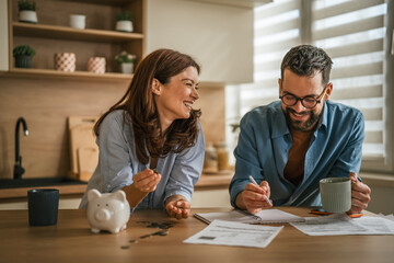 Happy couple budgeting and planning home finances