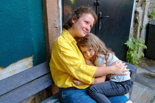 woman hugs her daughter