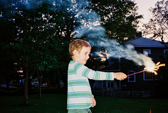 Child with sparkler on 4th of July