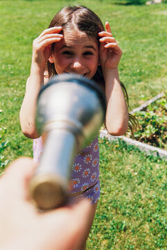 Child is about to be sprayed by hose