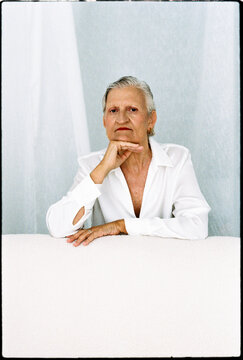 Senior model posing with hand on chin, 