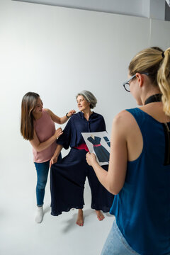 Fashion designers discussing clothing prototypes in creative studio