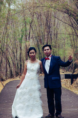 asia marry wed on road in bamboo forest