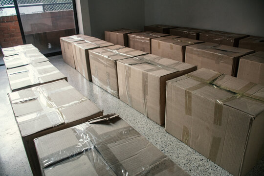 Large stack of cardboard boxes in a warehouse space