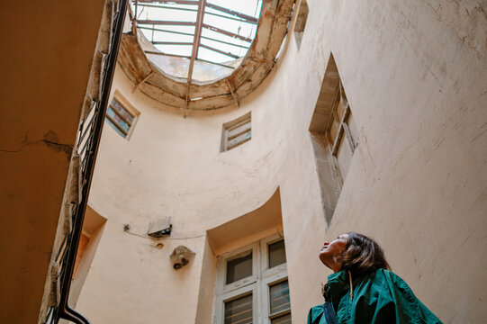 woman in old front door looking up