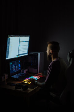Creative man coding alone at night