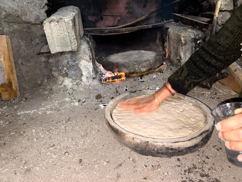 Traditional Bread Baking in Clay Pot Over Open Fire