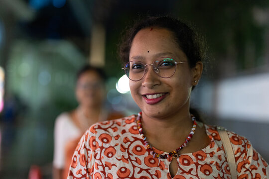 Beautiful Indian woman looking at camera at outdoors in nighttime