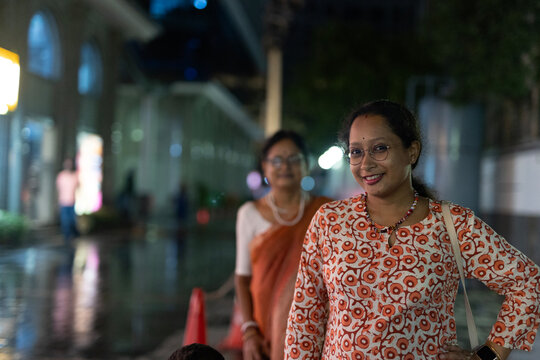 Beautiful Indian woman looking at camera at outdoors in nighttime