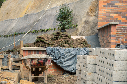 Construction site with stacked bricks and landscaping materials