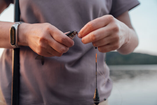 Unhooking a Small Fish from Fishing Line