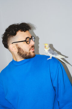 Man Whistling to Bird on Shoulder
