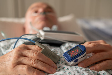Senior male patient in hospital, nasal cannula, medical tubing, respiratory support elderly clinical setting, oxygen therapy in nursing home, palliative care, Postoperative monitoring, health monitor
