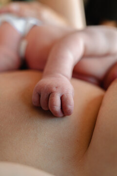 Newborn fist resting on skin