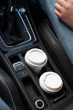 two takeaway coffees in car