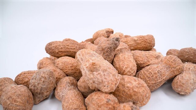 Macro of shelled peanuts on white background isolated