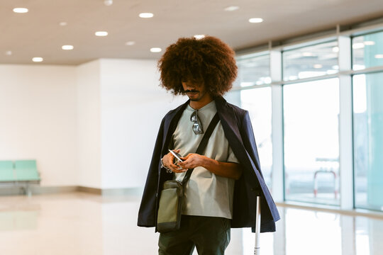 Stylish Traveler With Luggage at the Airport 