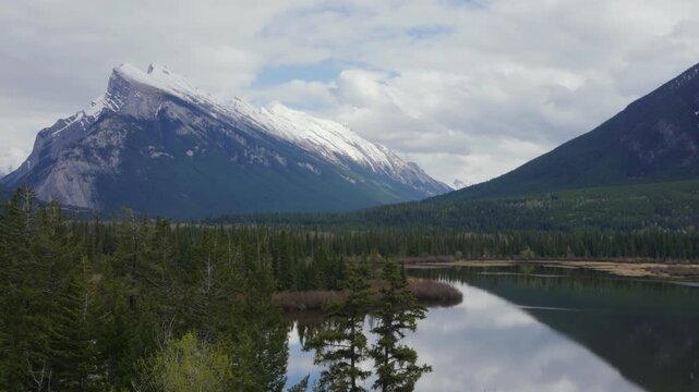 Vermilion Lakes reflecting Mount Rundle surrounded by forest in Banff National Park