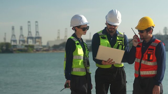 Civil engineering project managers executing coastal infrastructure development. Technical workforce discussing waterfront structural mechanics utilizing laptop database.