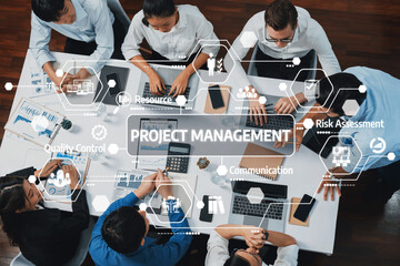 A top-down view of a diverse team participating in a project management meeting, highlighting...