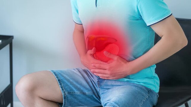 Man holding his side, suffering from liver pain. Man suffering from pain, hepatitis, cirrhosis, liver diseases.