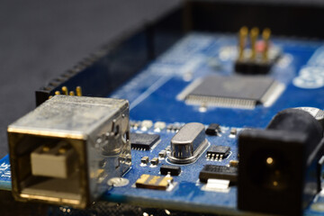 close up of printed circuit board with electronic components 