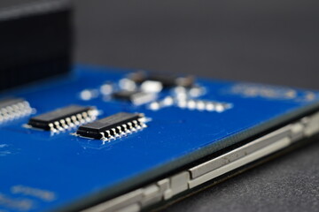 close up of printed circuit board with electronic components 