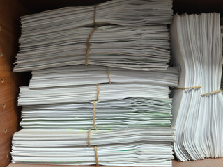Naklejka premium Paperwork Overload And Bureaucracy Stacks Of Documents Tied With String Representing Administrative Burden Compliance Challenges And Information Management Issues