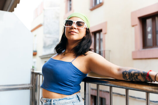 Stylish Woman Relaxing on Balcony