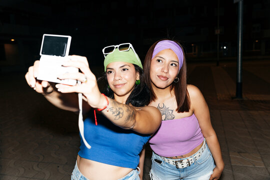 Friends Taking Selfie Outdoors at Night