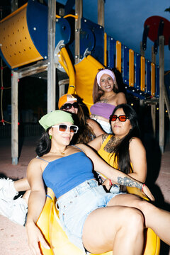 Friends Relaxing at Night Playground