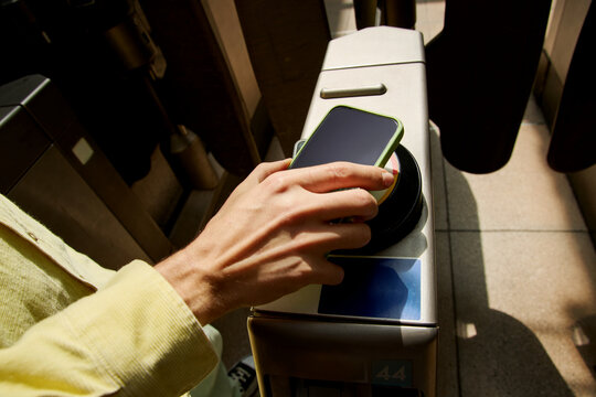Person tapping smartphone for contactless entry London