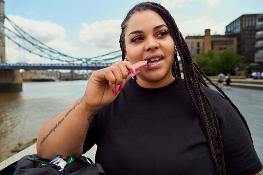 Woman vaping near Tower Bridge in London