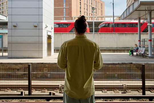 Man waiting at train platform in London