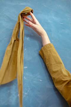 woman's hand with a ribbon of fabric