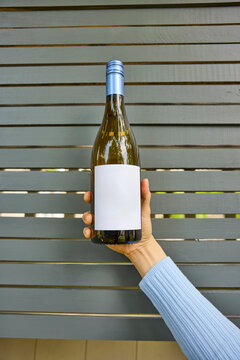 Woman holding a bottle of wine