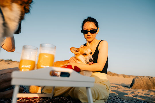 Sunny Beach Day With a Dog and Refreshing Drinks at Sunset
