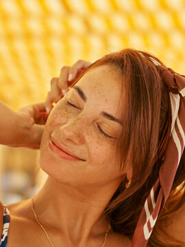 Young Woman Enjoying a Sunny Day Outdoors With a Vibrant Backdrop