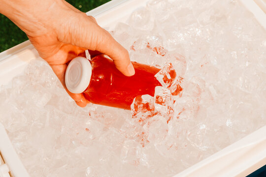 Colorful Drinks in Cooler Filled With Ice