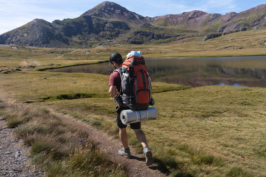 Backpacker by Mountain Lake
