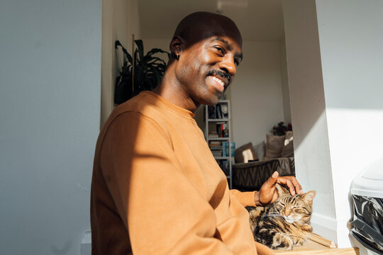Smiling at Cat by Window