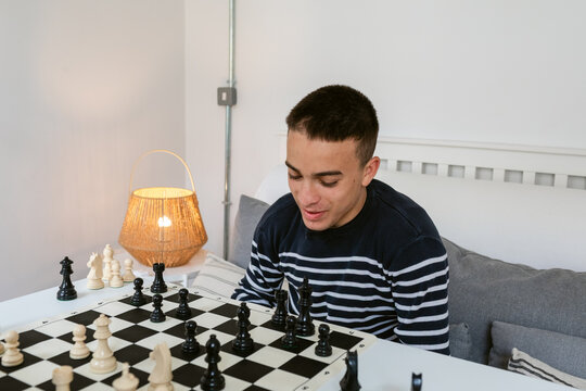 Young Man Focuses on Chess Match